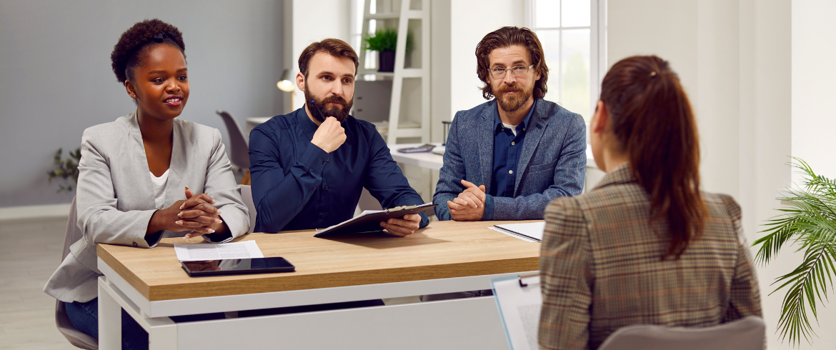 Image of four people discussing marketing