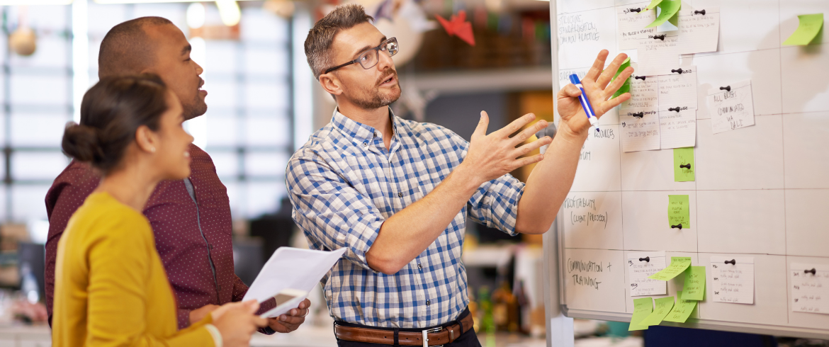 Image of three people discussing marketing strategy